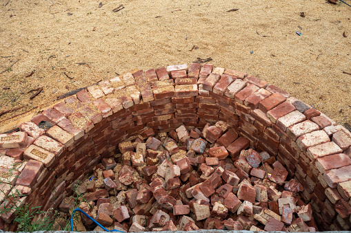 Building compact brick water harvesting tanks in rural Uttarakhand, India, for sustainable water conservation.