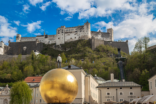 Salzburg: View of castle Hohensalzburg and monument to Paul Fuerst \