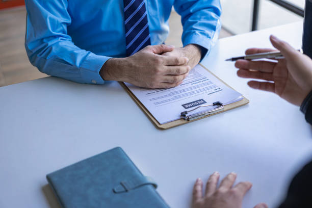 istock A young man explains his history to a business manager sitting in an interview. Contract recruitment and business employment Send resumes to recruiters for background checks. 1645943845