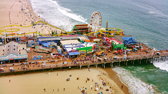 Aerial view of people enjoying at Santa Monica Beach and Santa Monica Pier, Santa Monica, California, USA.