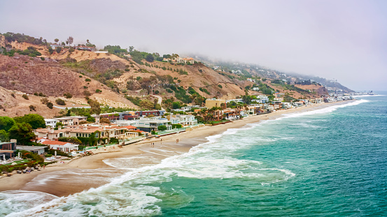 Aerial view of bungalows and hotels along coastline, California, USA.