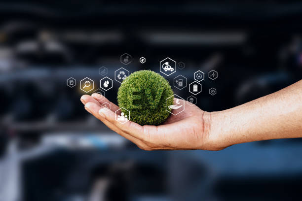 istock Hand of human holding global with EV icons. 1645951993