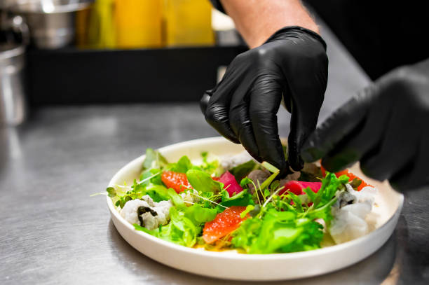 istock chef hands cooking Fresh sashimi salad with salmon fish, tuna and vegetables on kitchen 1645953037