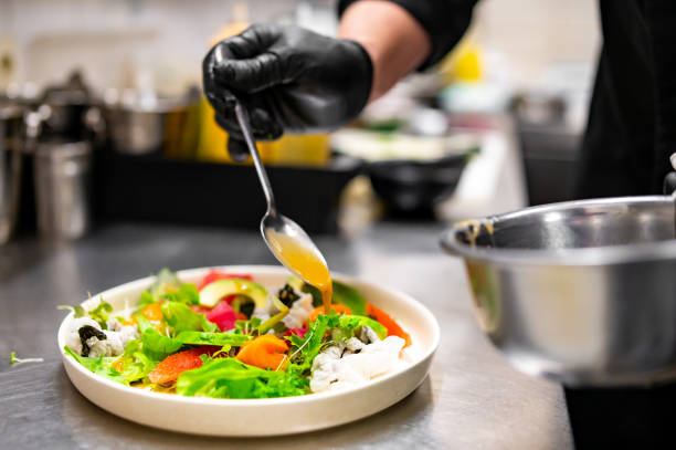 istock chef hands cooking Fresh sashimi salad with salmon fish, tuna and vegetables on kitchen 1645953039