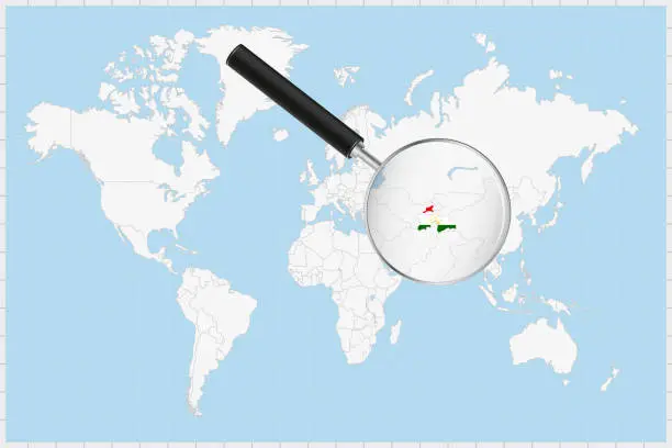 Vector illustration of Magnifying glass showing a map of Tajikistan on a world map.