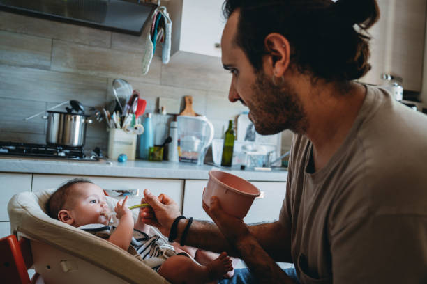 istock A father is feeding his son in the kitchen at home 1645967172