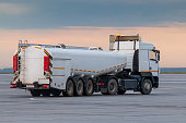 White tank truck aircraft refueler at the airport apron