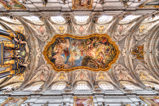 Baroque ceiling construction with magnificent paintings and church organ in the central nave of the monastery of St. Emmeram in Regensburg, Bavaria