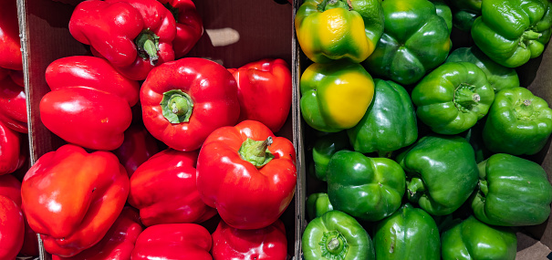 Red and green peppers. Ripe and juicy peppers in the market. Pepper.