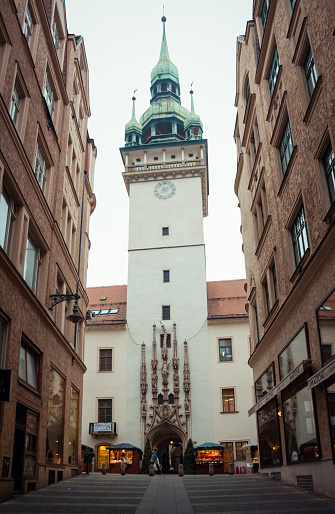 Brno, Czech Republic - December 16 2014: Vertical wide-angle photo of Town Hall tower in pedestrian zone of old town in Brno week prior to Christmas