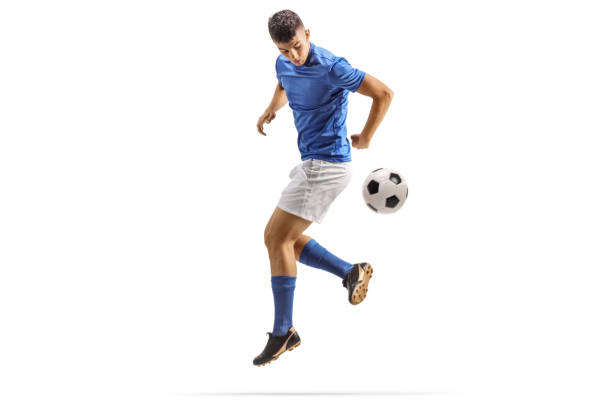 istock Football player kicking a ball with back heel 1646018381
