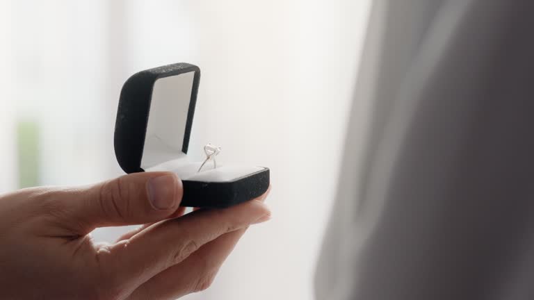 Engagement, couple hands and ring box for proposal of people together for love, care and commitment. A man and woman with jewellery for promise and gift on valentines day while asking question