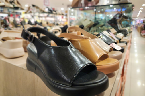 Woman shoes and sandals on display in boutiques and malls, woman footwear on the display at market