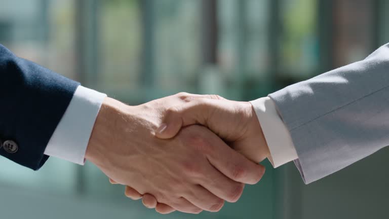 Business people, corporate partnership and shaking hands in support, success or collaboration for hiring. Closeup, teamwork and handshake for deal, praise and b2b meeting for HR, recruitment or trust