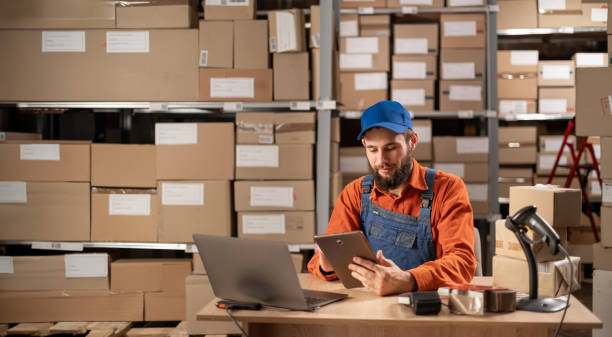 istock Portrait of a professional male worker uses digital tablet with inventory checking software in the retail warehouse. Delivery, Distribution Center. 1646034426