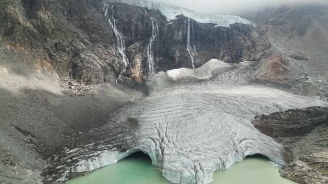 Europe, Italy, Sondrio Valmalenco Alpe Gera-  drone view of Fellaria glacier in Alps -  rapid melting of ice iceberg causes sea level rise. Global warming and climate change cause drought and aridity