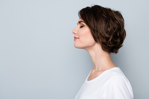 Side profile photo of adorable woman with bob hairstyle dressed white t-shirt eyes closed enjoy moment isolated on gray color background.