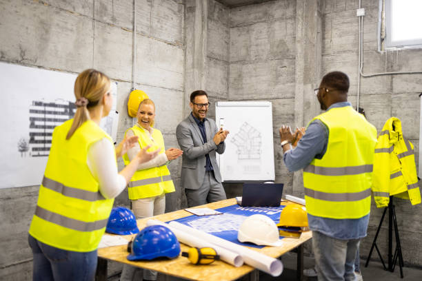 istock Team of structural engineers and architects giving applause for successfully completing the building project. 1646105084