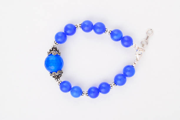 istock Top view of blue stone bracelet on white background 1646181156