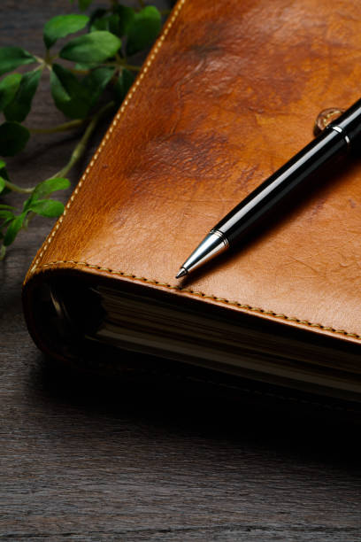 istock Ring bound planner and pen on wooden table 1646203676