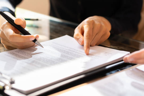 istock Two Businesspeople Working On Contract Paper 1646204916