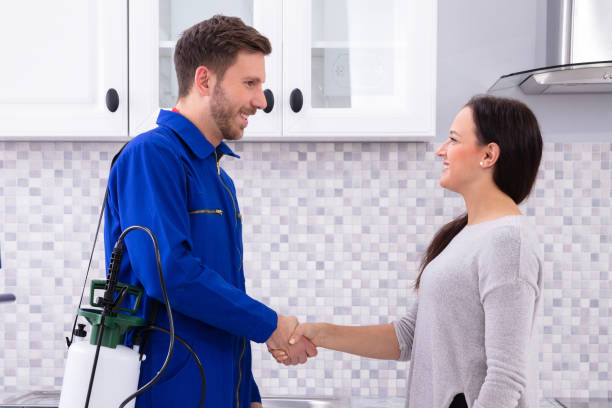 Pest Control Worker Shaking Hands With Woman stock photo