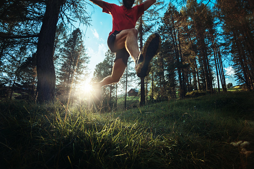 Man jumping over mountain road outdoor travel lifestyle adventure vacations activity in Norway freedom success concept happy positive vibes emotions