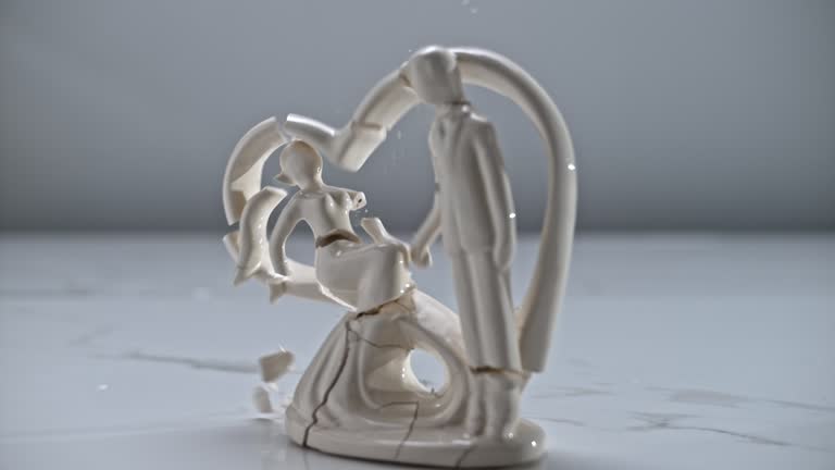 SLO MO LD Figurine falling to the ground and breaking into smithereens