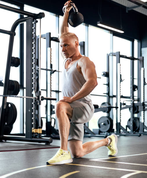istock Middle aged athlete exercising kettlebell drills in gym. 1646247348