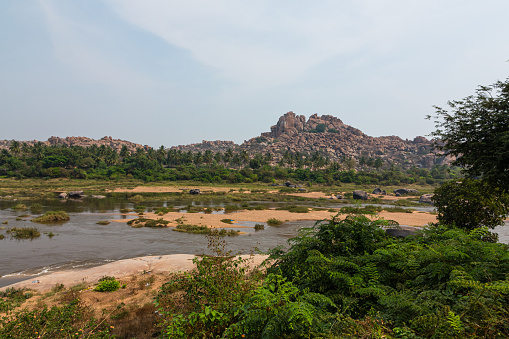 Hampi is an old place in India with broken buildings from long ago. There are temples and palaces, and it looks unique with big rocks. People go there to see history and cool views.