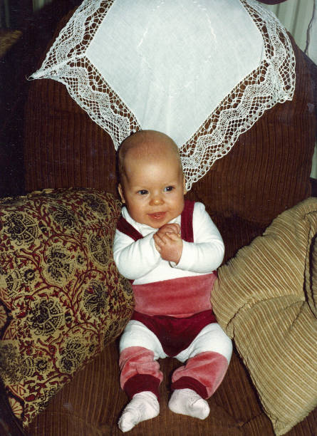 Retro Baby boy sitting in chair stock photo