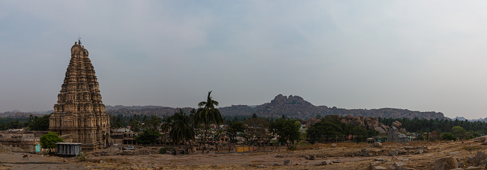 Hampi is an old place in India with broken buildings from long ago. There are temples and palaces, and it looks unique with big rocks. People go there to see history and cool views.