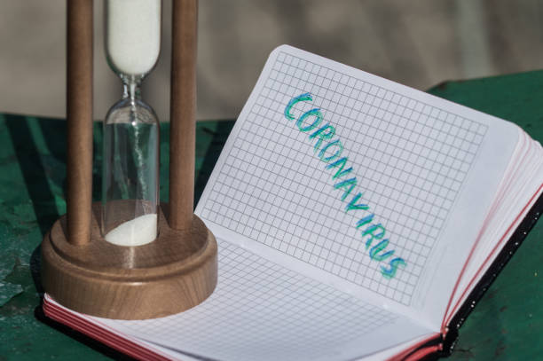 istock Notebook and sandglass on metal stand 1646271826
