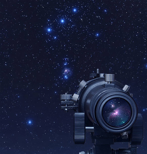 Close-up of telescope on astronomy background A picture of telescope pointed at Orion nebula telescope photos stock pictures, royalty-free photos & images