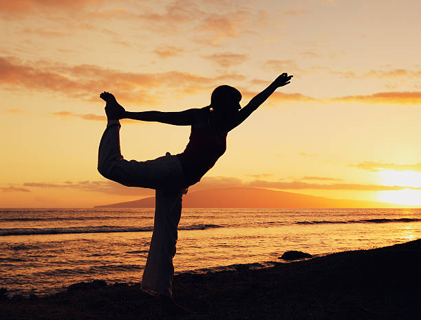 istock Woman Practicing Yoga at Sunset 164630594