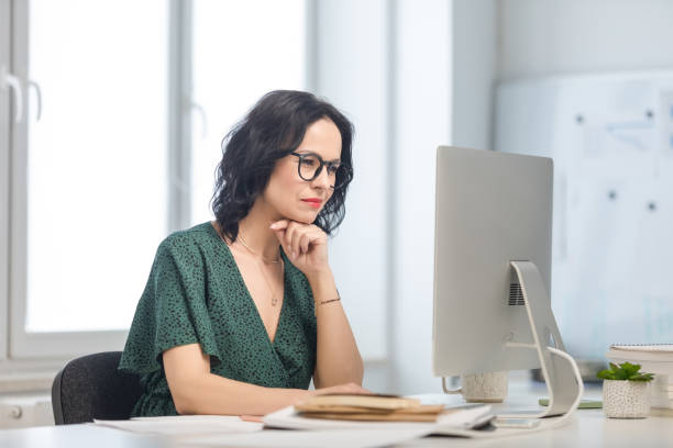 istock Mature woman working on computer in the office 1646322334