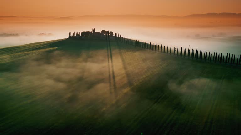 Drone point of view fog over tranquil Tuscany landscape