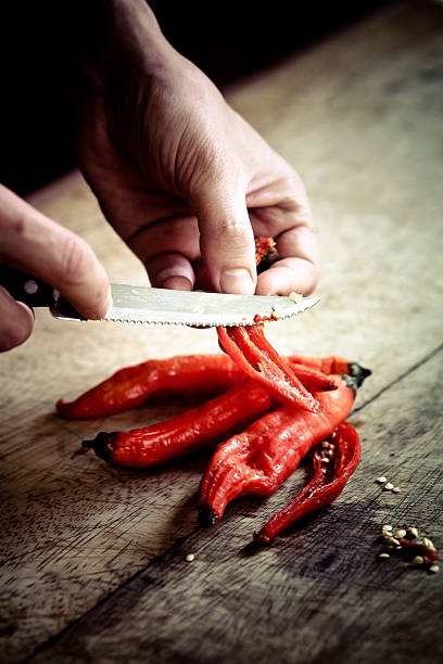 Man chopping chilli pepper stock photo