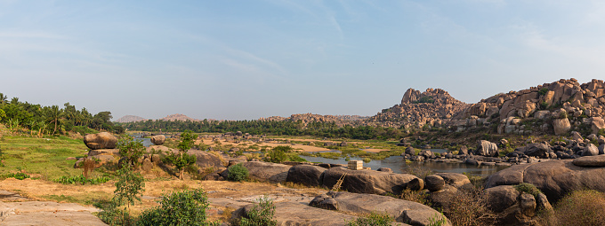 Hampi is an old place in India with broken buildings from long ago. There are temples and palaces, and it looks unique with big rocks. People go there to see history and cool views.