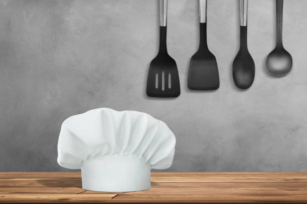 istock Wooden table with empty space and cooking hat and cooking utensils 1646358348