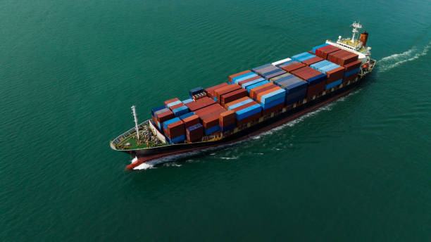 istock aerial front view cargo container ship carrying in sea import export goods and distributing products to dealer consumers, global business transportation by container ship open sea, 1646366873