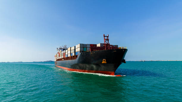 istock cargo container ship sailing in sea to import export goods and distributing products to dealer and consumers across worldwide, by container ship Transport business,  drone shot 1646366878