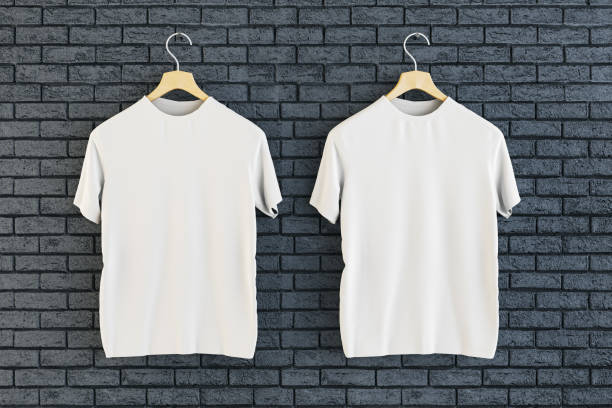 istock Two empty white t-shirts hanging on black brick wall background. Ad, textile and fashion concept. 3D Rendering. 1646367036