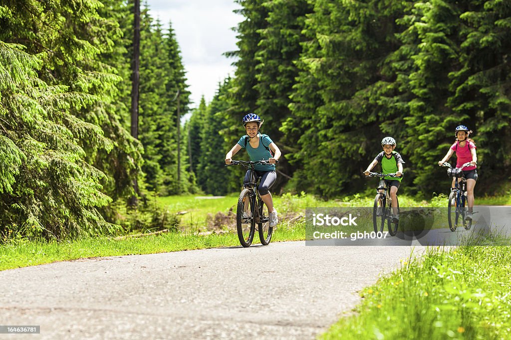 Active family biking Active family riding bikes  14-15 Years Stock Photo