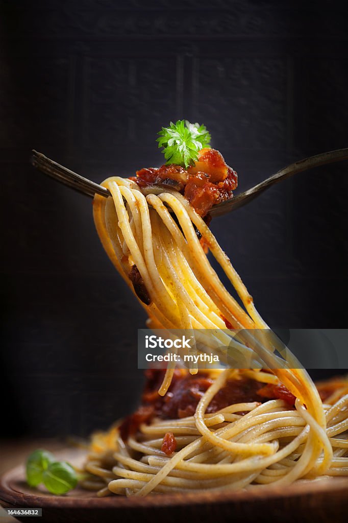 Pasta with tomato sauce Italian food. Pasta spaghetti with tomato sauce, olives and garnish. Pasta macro on fork Cherry Tomato Stock Photo