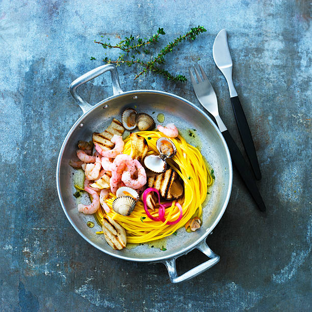 Freshly made pasta dish with shrimps and mussels stock photo