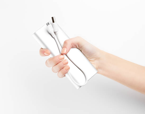 istock Silver power bank on hand isolate. Power bank for charging mobile devices. Smart phone charger with power bank. battery bank. External battery for mobile devices. 1646371873