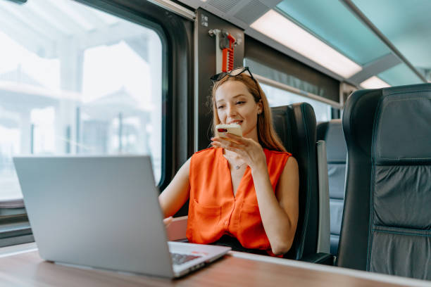 istock Woman seamlessly working on her laptop in the train 1646377111