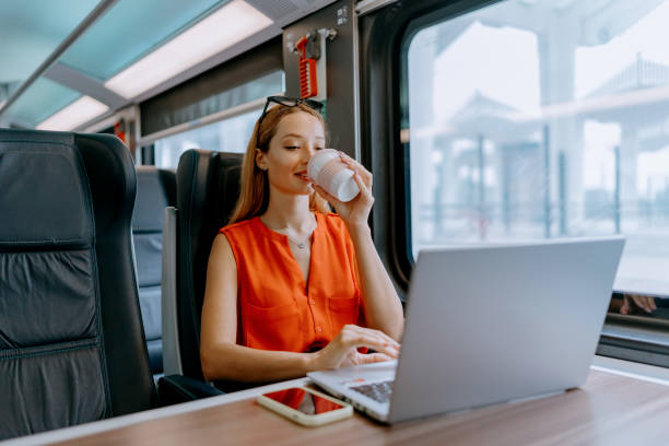 istock Woman typing away on her laptop during train ride 1646377302