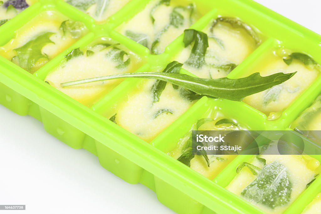 Preserved herbs for cooking Fresh Herb Ice Cubes. Fresh oganic herbs in olive oil ice cubes Ice Cube Tray Stock Photo